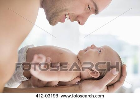 Father cradling newborn baby View Large Photo Image Stock Photo - Father cradling newborn baby. Fotosearch