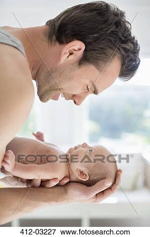 Father cradling newborn baby View Large Photo Image Stock Photo - Father cradling newborn baby. Fotosearch