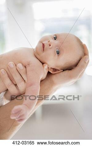 Father cradling newborn baby View Large Photo Image Stock Photography - Father cradling newborn baby. Fotosearch