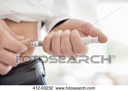 Man giving himself injection in stomach View Large Photo Image Stock Image - Man giving himself injection in stomach. Fotosearch