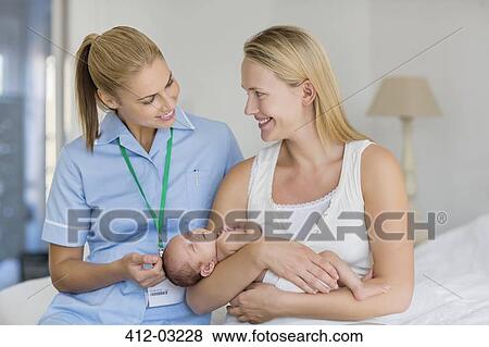 Mother and nurse with newborn baby View Large Photo Image Stock Photo - Mother and nurse with newborn baby. Fotosearch