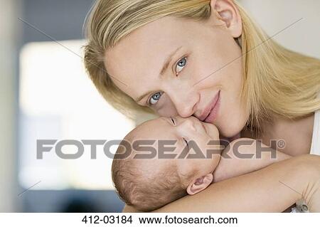 Mother cradling newborn baby View Large Photo Image Picture - Mother cradling newborn baby. Fotosearch