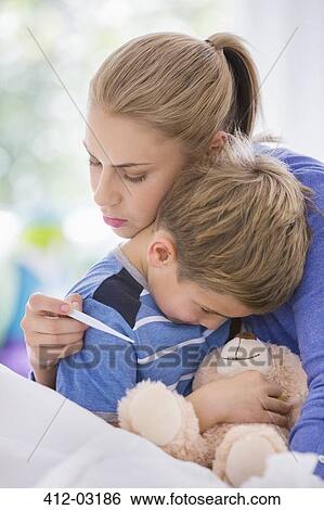 Mother hugging sick son in bed View Large Photo Image Stock Photograph - Mother hugging sick son in bed. Fotosearch