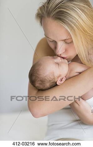 Mother kissing newborn baby View Large Photo Image Stock Photograph - Mother kissing newborn baby. Fotosearch