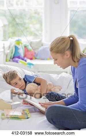 Mother reading to son in bed View Large Photo Image Stock Photo - Mother reading to son in bed. Fotosearch