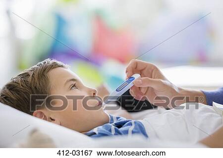 Mother taking son's temperature View Large Photo Image Stock Photo - Mother taking son's temperature. Fotosearch
