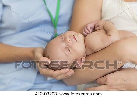 Nurse and mother cradling newborn baby View Large Photo Image Stock Image - Nurse and mother cradling newborn baby. Fotosearch