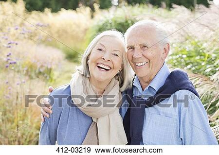 Older couple hugging outdoors View Large Photo Image Stock Photo - Older couple hugging outdoors. Fotosearch