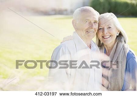 Stock Photo - Older couple smiling outdoors. Fotosearch