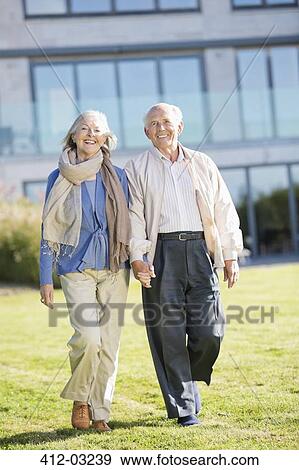 Older couple walking outdoors View Large Photo Image Stock Photo - Older couple walking outdoors. Fotosearch