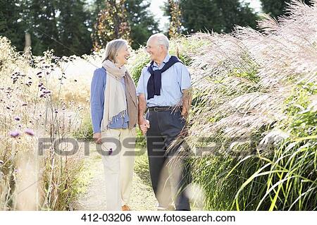 Older couple walking outdoors View Large Photo Image Stock Photograph - Older couple walking outdoors. Fotosearch