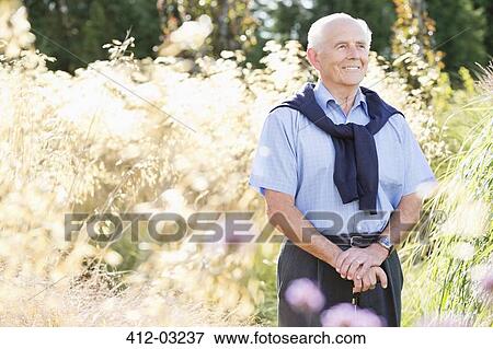 Older man smiling outdoors View Large Photo Image Stock Photo - Older man smiling outdoors. Fotosearch