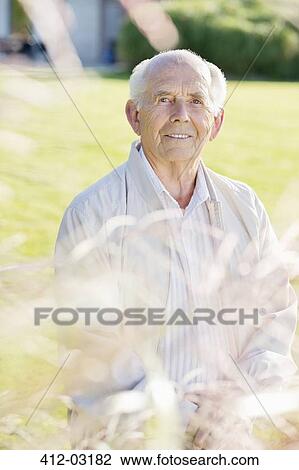 Older man standing in backyard View Large Photo Image Stock Image - Older man standing in backyard. Fotosearch