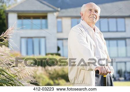 Older man walking with cane outdoors View Large Photo Image Stock Image - Older man walking with cane outdoors. Fotosearch