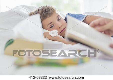 Sick boy laying in bed View Large Photo Image Stock Image - Sick boy laying in bed. Fotosearch