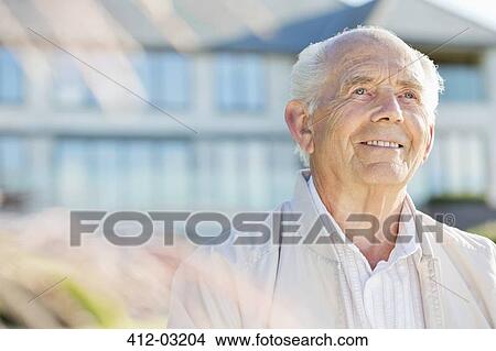 Smiling older man standing outdoors View Large Photo Image Picture - Smiling older man standing outdoors. Fotosearch