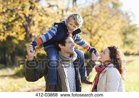 Stock Photo - Caucasian family walking in park. Fotosearch