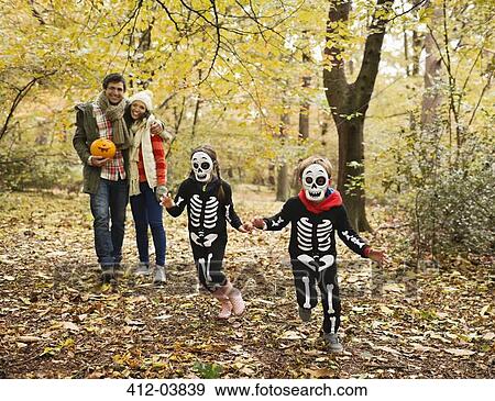 Stock Photo - Children in skeleton costumes playing in park. Fotosearch