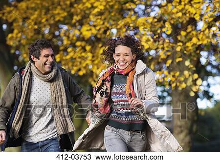 Couple running together in park View Large Photo Image Stock Image - Couple running together in park. Fotosearch