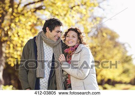 Couple walking together in park View Large Photo Image Stock Photography - Couple walking together in park. Fotosearch