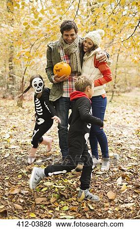 Couple with children in skeleton costumes in park View Large Photo Image Stock Photo - Couple with children in skeleton costumes in park. Fotosearch