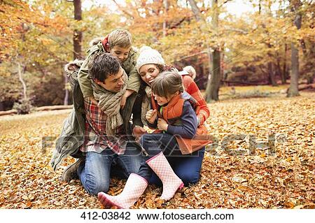 Stock Image - Family playing together in park. Fotosearch