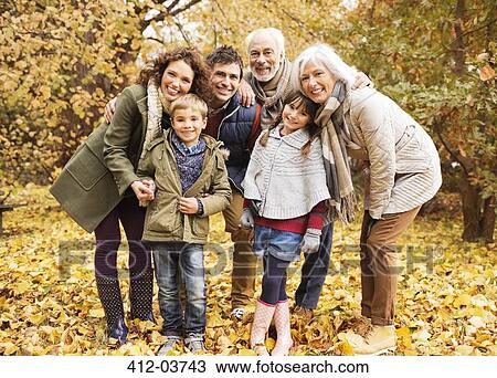 Family smiling together in park View Large Photo Image Stock Image - Family smiling together in park. Fotosearch