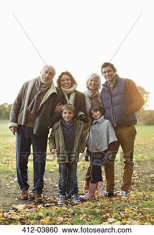 Family smiling together in park View Large Photo Image Stock Image - Family smiling together in park. Fotosearch