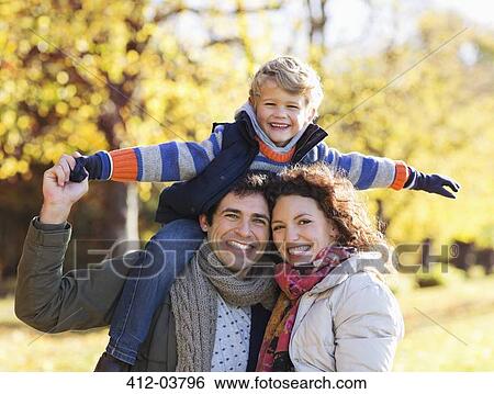 Family smiling together in park View Large Photo Image Stock Photograph - Family smiling together in park. Fotosearch
