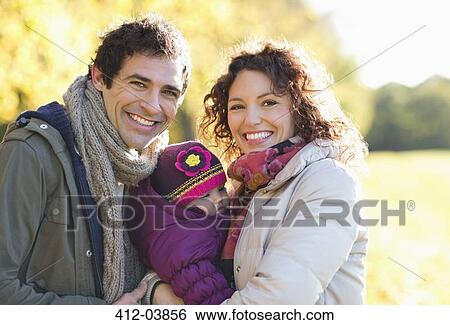 Stock Photograph - Family smiling together in park. Fotosearch