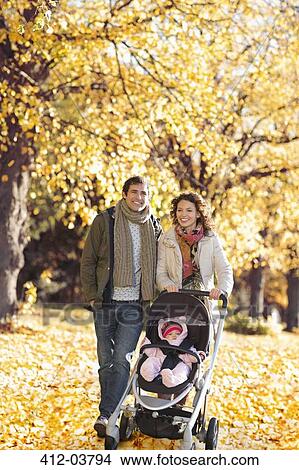 Picture - Family walking together in park. Fotosearch