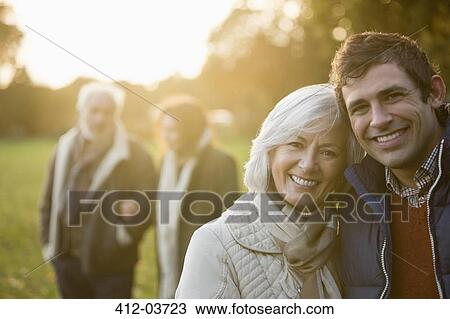 Stock Image - Family walking together in park. Fotosearch
