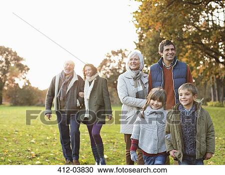 Family walking together in park View Large Photo Image Stock Image - Family walking together in park. Fotosearch