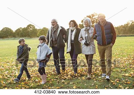Family walking together in park View Large Photo Image Stock Image - Family walking together in park. Fotosearch