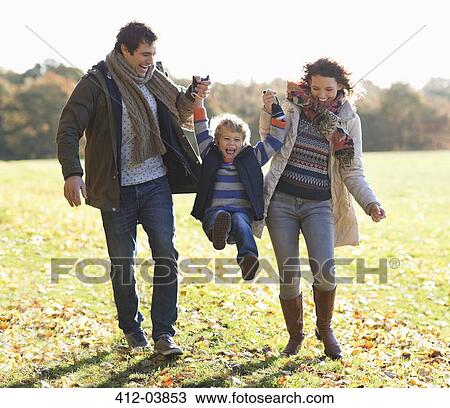 Family walking together in park View Large Photo Image Stock Image - Family walking together in park. Fotosearch