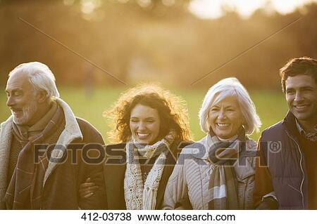 Family walking together in park View Large Photo Image Stock Photo - Family walking together in park. Fotosearch