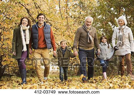 Stock Photo - Family walking together in park. Fotosearch