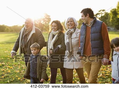 Stock Photo - Family walking together in park. Fotosearch