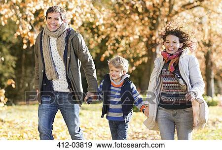 Family walking together in park View Large Photo Image Stock Photo - Family walking together in park. Fotosearch