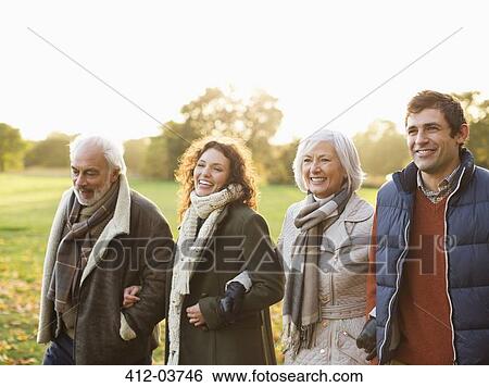 Stock Photograph - Family walking together in park. Fotosearch