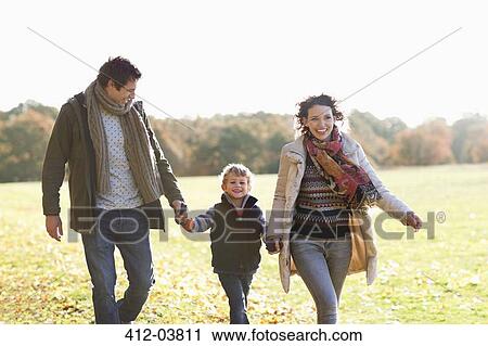 Stock Image - Family walking together outdoors. Fotosearch