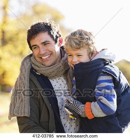 Father and son playing in park View Large Photo Image Stock Photography - Father and son playing in park. Fotosearch