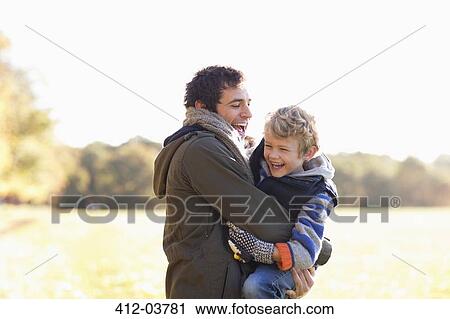 Stock Image - Father and son playing outdoors. Fotosearch