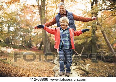 Man and grandson playing in park View Large Photo Image Stock Photograph - Man and grandson playing in park. Fotosearch