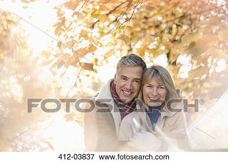 Older couple hugging in park View Large Photo Image Stock Photo - Older couple hugging in park. Fotosearch