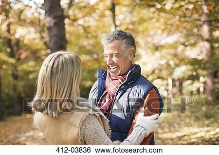 Older couple hugging in park View Large Photo Image Stock Photograph - Older couple hugging in park. Fotosearch