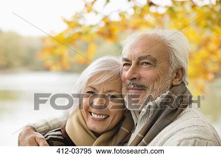 Older couple hugging in park View Large Photo Image Stock Photography - Older couple hugging in park. Fotosearch