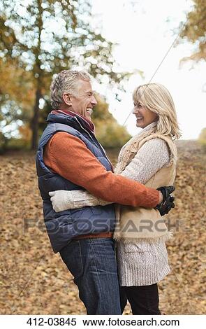 Stock Photography - Older couple hugging in park. Fotosearch