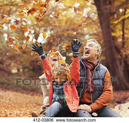 Older couple playing with grandson in autumn leaves View Large Photo Image Stock Photograph - Older couple playing with grandson in autumn leaves. Fotosearch