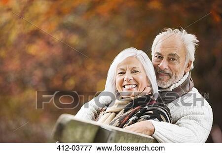Older couple sitting on park bench View Large Photo Image Stock Photo - Older couple sitting on park bench. Fotosearch